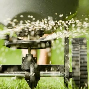 a sprinkler being sprayed with water