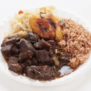 Slowly seasoned cooked oxtails served over rice-n-peas.