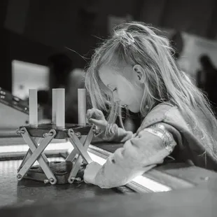 Deep in thought as she builds her tower for the earthquake simulator.