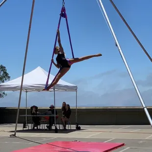 Acrobatic performance outside of building.