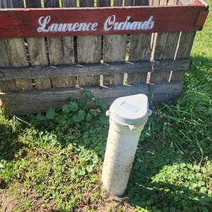 a wooden crate with a bucket in it