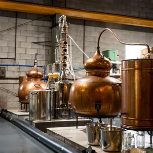 Two copper alembic stills and one column still.