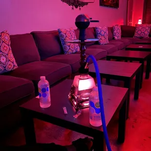 a hookah lounge with couches and tables