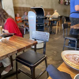 a woman sitting at a table in a restaurant