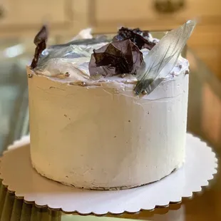 a white frosted cake on a plate