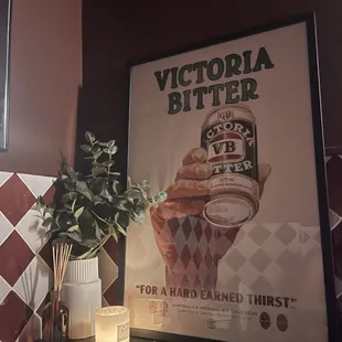 a candle and a poster on a table