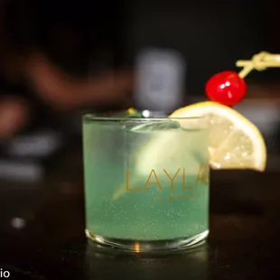 a close up of a cocktail with a cherry on top