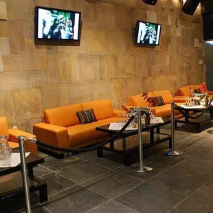 a row of orange couches in a restaurant