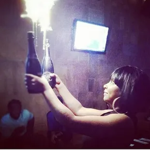 a woman holding a bottle of wine