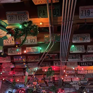 a variety of license plates hanging from the ceiling