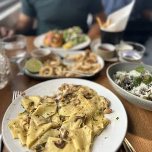 a plate of pasta and a bowl of salad