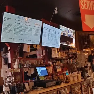 a bar with menus on the wall
