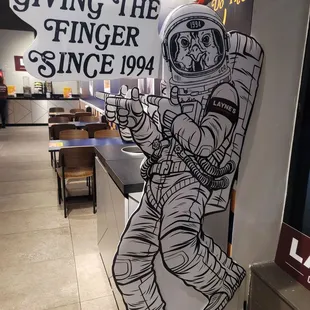 an astronaut holding a sign
