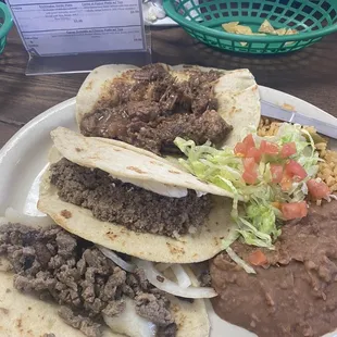 Super taco plate - includes ( asada taco, guisada taco, carne picada taco, w/ rice and beans)