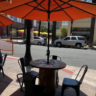 tables and chairs with umbrellas