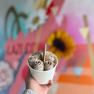 a person holding a bowl of ice cream