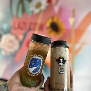 a hand holding a jar of iced coffee and a jar of iced coffee