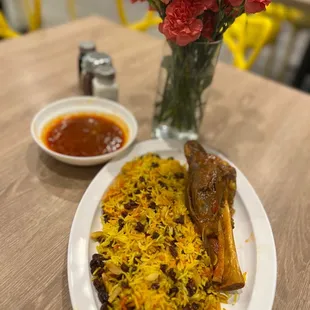 a plate of food and a vase of flowers