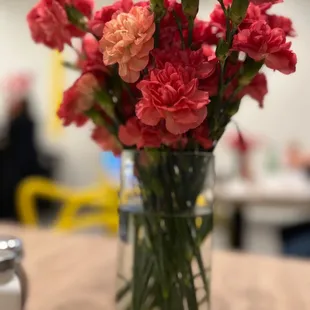 a vase of carnations on a table
