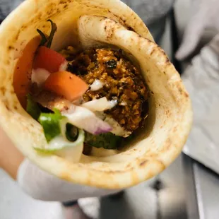 a person holding a pita