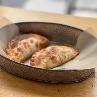 two empanadas in a basket