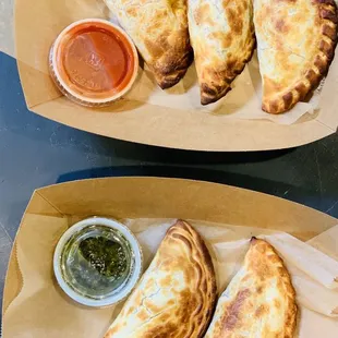 two plates of empanadas