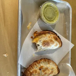 a half eaten sandwich on a tray