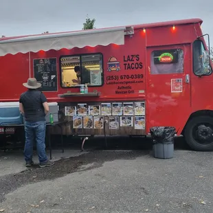 a man standing in front of a food truck