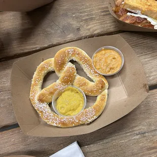 Pretzel with mustard and queso