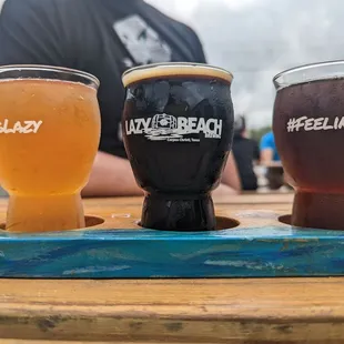 three glasses of beer on a tray