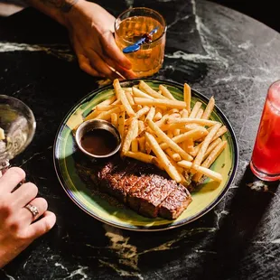 a plate of steak and french fries