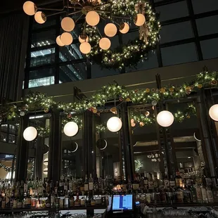 a bar with a chandelier in the background