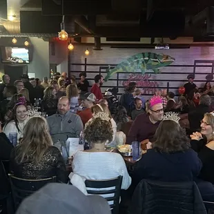 a large group of people eating at a restaurant
