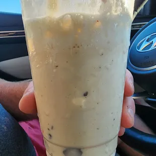 a hand holding a drink