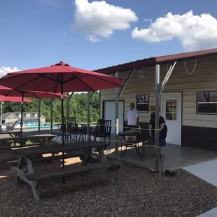 a picnic area with tables and umbrellas