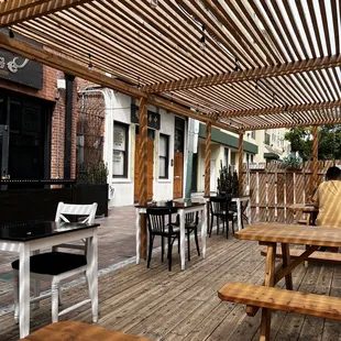 a patio with tables and benches