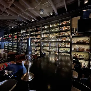 a bar with shelves full of liquor bottles