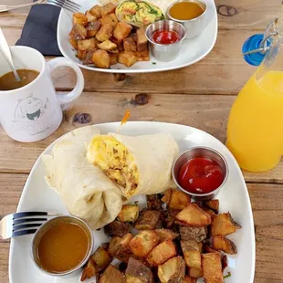 Top plate: veggie breakfast burrito  Bottom plate: Chorizo burrito with potatoes