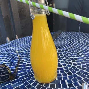 Fresh squeezed orange juice served in a bottle