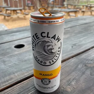 a can of beer on a picnic table