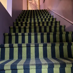 a picture of a painting on the wall above the stairs