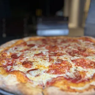 pepperoni and cheese on a pizza pan