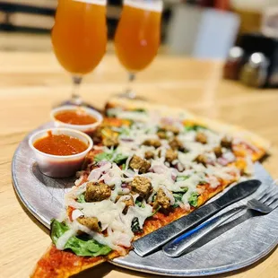a slice of pizza and a glass of beer