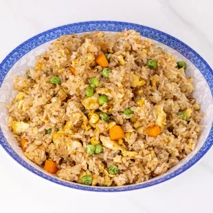 a bowl of fried rice with peas and carrots