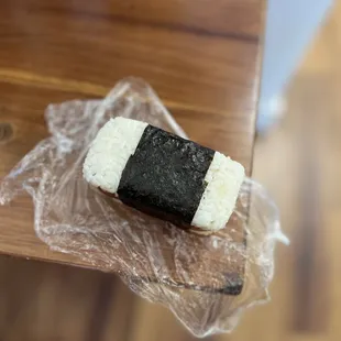 a piece of sushi on a plastic wrap