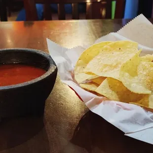 a bowl of chips and a bowl of salsa
