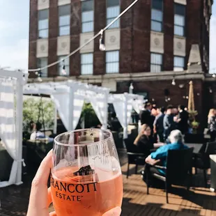 a person holding a glass of wine