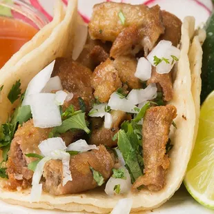 a close up of a taco with meat and vegetables