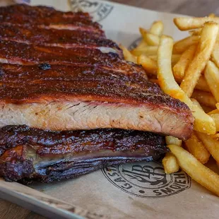 a plate of ribs and french fries