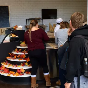 a group of people standing in front of a counter